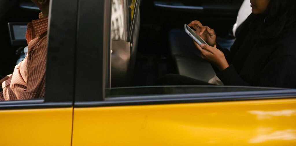 Traveler booking an Uber ride in India using a smartphone